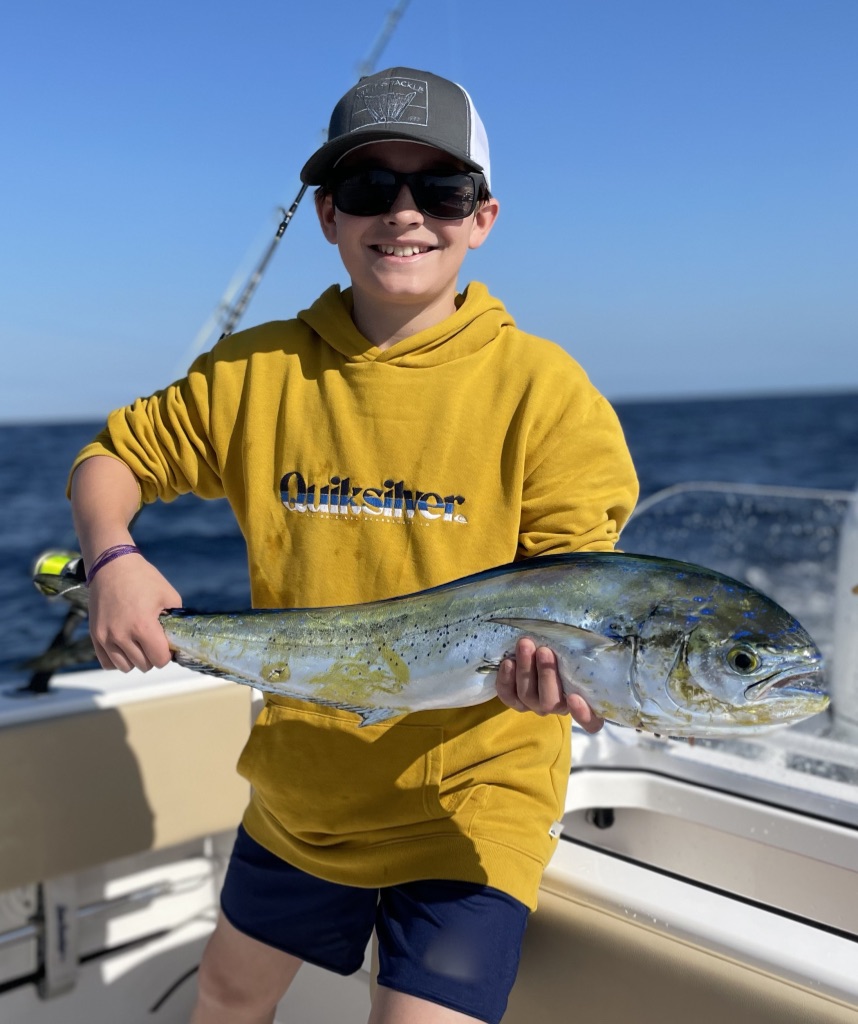 Child with moderately-sized fish he caught
